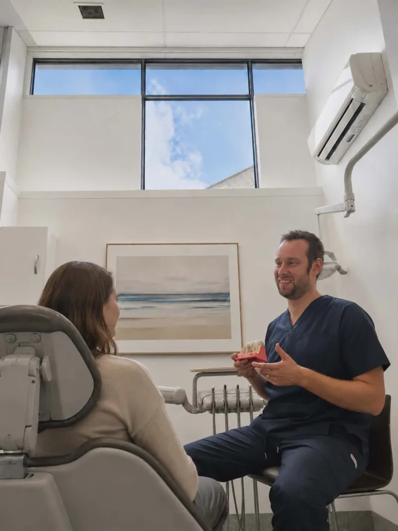 Dr Louis George consulting with a patient at Sunny Dental Buderim